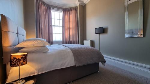 a bedroom with a large bed with a window at Beautiful City Centre Apartment Close to Minster in York