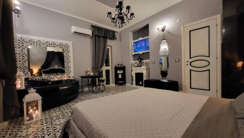 a bedroom with a white bed and a fireplace at Anzio d'aMare in Anzio