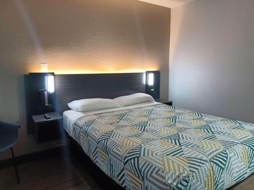 a bedroom with a large bed with two pillows on it at Motel 6-Fresno, CA - Blackstone North in Fresno