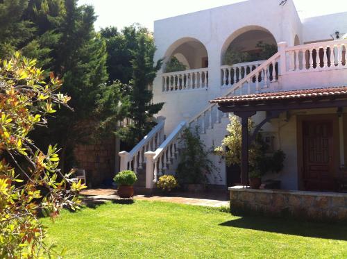 an external view of a house with a staircase at Studios Irene in Skala