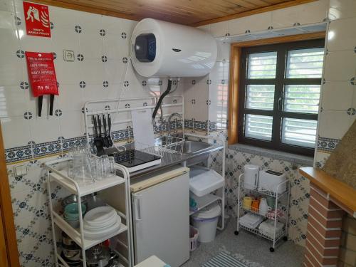 a small kitchen with a sink and a stove at Casa das Neves in Manteigas