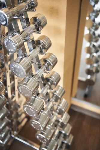 a bunch of silver dumbbells on a wall at Best Western Plus Kurhotel an der Obermaintherme in Bad Staffelstein