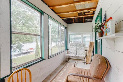 a living room with two chairs and windows at Red Grill in Castleton