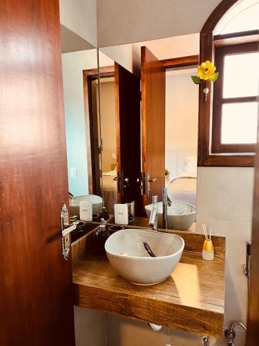 a bathroom with a large bowl sink and a mirror at Hotel do Parque - Cunha in Cunha