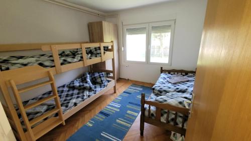 a room with two bunk beds and a window at Apartman Progresso in Valjevo