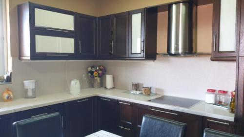 a kitchen with black cabinets and a counter top at Wonderful Spot to Recharge in Kalamata