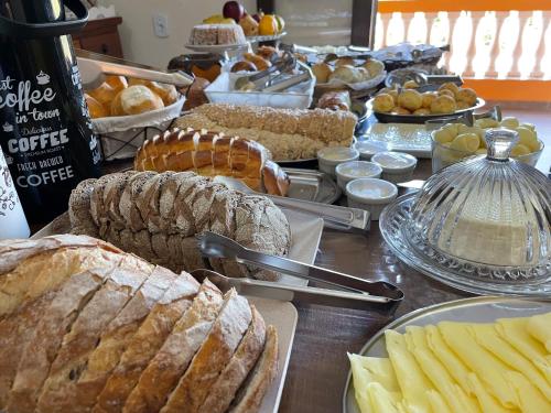 a buffet of bread and pastries on a table at Hotel do Parque - Cunha in Cunha