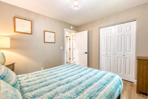 a bedroom with a bed with a blue comforter at Wildwood in Fletcher