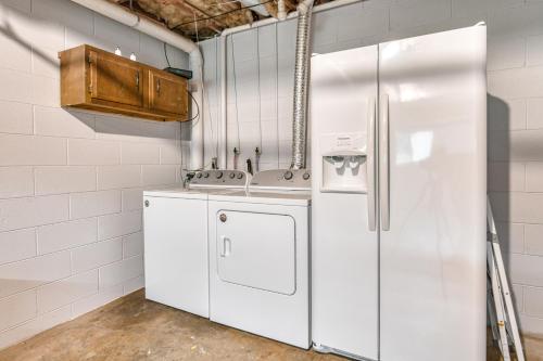 a kitchen with a white refrigerator and a sink at Wildwood in Fletcher