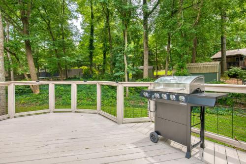 a grill on a deck with a fence and trees at Wildwood in Fletcher