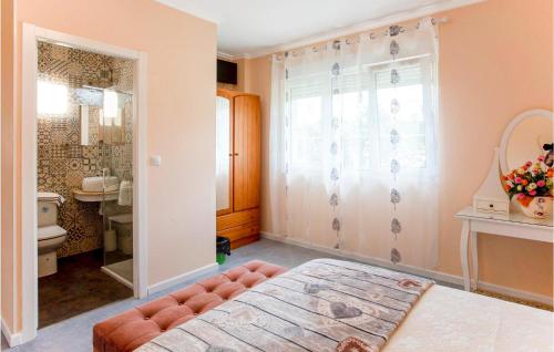 a bedroom with a bed and a bathroom at 4 Bedroom Awesome Home In Chantada in Chantada