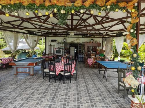 a restaurant with ping pong tables and chairs in a room at Villa Monica in Montenegro