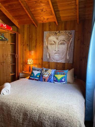 a bedroom with a bed with a statue of a woman at CASA PALAFITO Interior. in Pucón