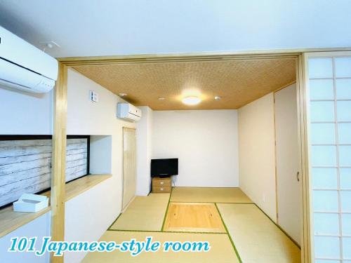 an empty room with a tv in the corner of a room at Mcity in Wakasa in Naha