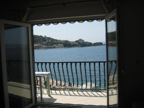 a view of the water from the balcony of a house at Apartments Waterfront Ivan in Podgora