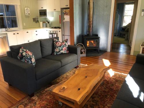a living room with a couch and a wooden coffee table at Old School House in Queenstown