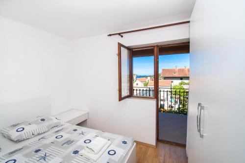 Ένα ή περισσότερα κρεβάτια σε δωμάτιο στο Apartments Vita Niko
