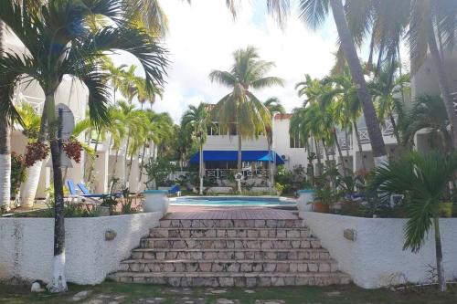 un complejo con palmeras y piscina en Chrisanns Hidden Cove 2 bedroom en St Mary