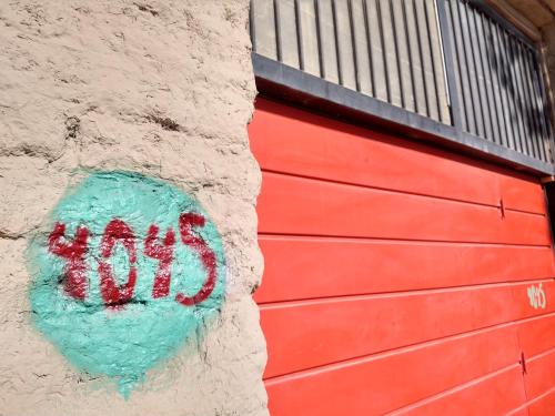 a red garage door with a sign on it at El Parralito in Mendoza