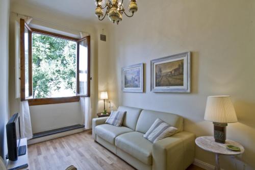 a living room with a couch and a window at San Marco Apartment in Florence