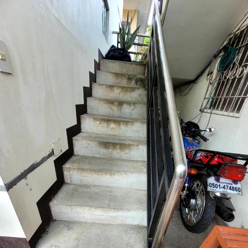 a set of stairs with a motorcycle parked next to it at ANDY'S PLACE in Legazpi