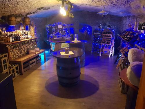 a bar with a barrel in a room with blue lights at Gästehaus zum Felsen in Überlingen