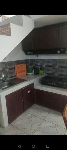 a kitchen with a sink and a counter top at ZG Home Solo in Bonorejo