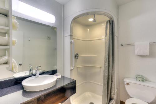 a bathroom with a shower and a sink and a toilet at Motel 6-Tigard, OR - Portland South - Lake Oswego in Tigard