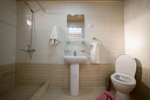 a bathroom with a sink and a toilet and a shower at Islam Khodja in Khiva