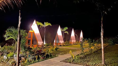 a row of houses lit up at night at Hardin De Marbella in El Nido