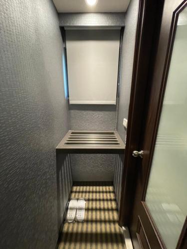 a walk in closet with two white shoes in it at Ueno Hirokoji 428 in Taipei