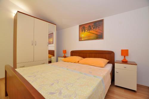 a bedroom with a bed and a white cabinet at Vila Ana Mirela in Slatine