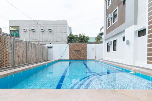 a swimming pool in the middle of a building at RedDoorz Plus @ d'Builders Poblacion - BGC in Manila