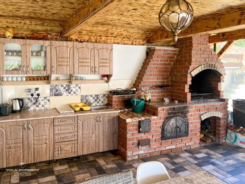 a kitchen with a brick oven in a room at Casa Popescu in Călimăneşti