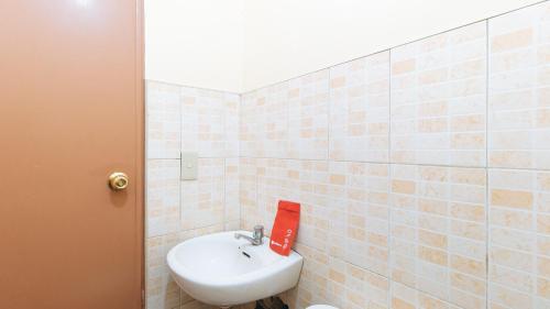a bathroom with a sink and a toilet in it at RedDoorz @ Golden Park Inn La Union in Lossoc