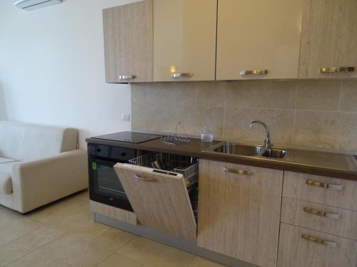 a kitchen with a sink and a stove at Residence San Bull in Metaponto