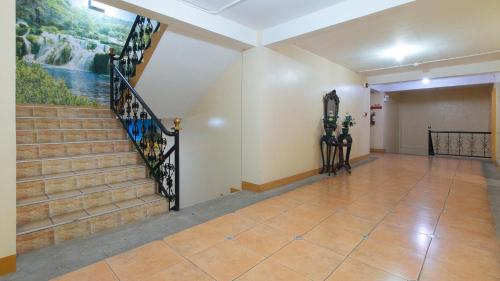 a hallway with stairs and a painting on the wall at RedDoorz @ Golden Park Inn La Union in Lossoc