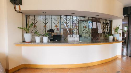 a bar in a building with flowers on the wall at RedDoorz @ Golden Park Inn La Union in Lossoc