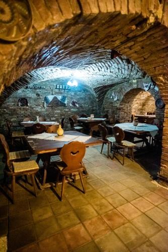 a room with tables and chairs in a brick wall at HOTEL MARION in Dumbrăveni
