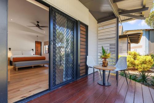 a patio with a table and chairs and a bedroom at Mercure Darwin Airport Resort in Darwin