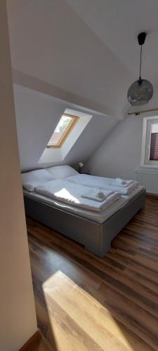 a bedroom with a bed in a attic at Apartamenty Mikołajki na Kajki in Mikołajki