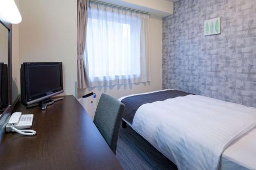 Tempat tidur dalam kamar di Comfort Hotel Hakodate