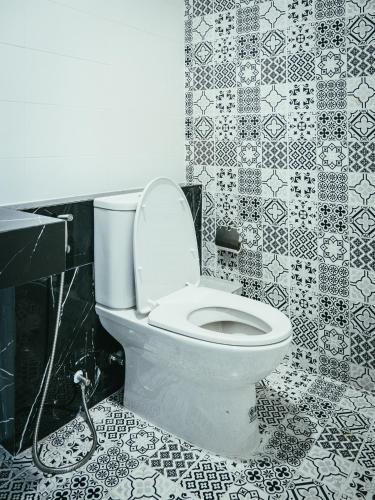 a bathroom with a toilet with a hose at N24 Chonburi in Chon Buri