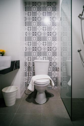 a bathroom with a white toilet and a shower at N24 Chonburi in Chon Buri