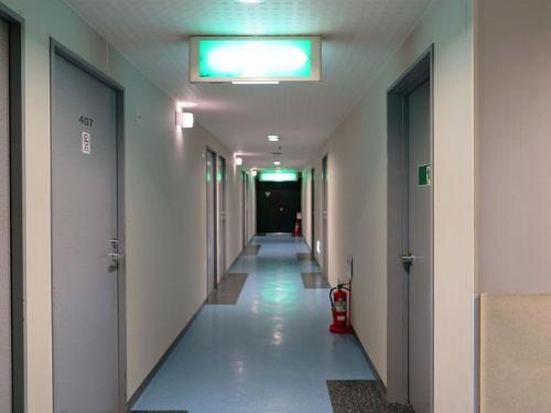 an empty hallway in a hospital with a fire hydrant at ホテルスターらんど in Tsuru 