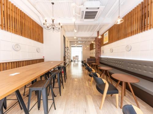 a long dining room with a long table and chairs at Hiromas Hostel in Ueno in Tokyo