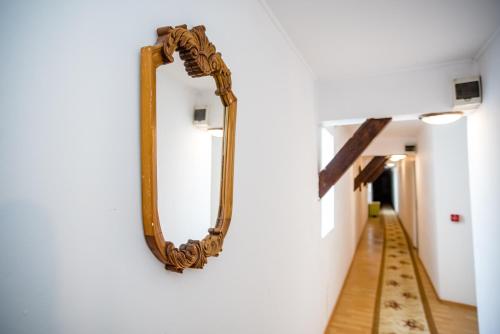 a mirror hanging on a wall next to a hallway at HOTEL MARION in Dumbrăveni