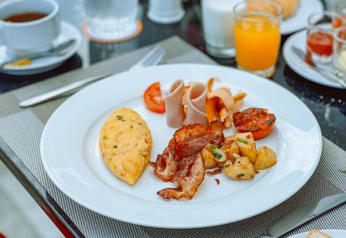 a white plate of food on a table at Grand Lord Hotel & Residence - Khao chi chan Pattaya in Na Jomtien