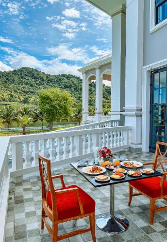 a balcony with a table with food on it at Grand Lord Hotel & Residence - Khao chi chan Pattaya in Na Jomtien