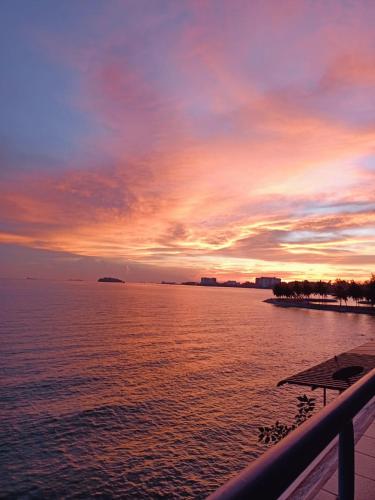 a sunset over a large body of water at Port Dickson Seaview Homestay in Port Dickson